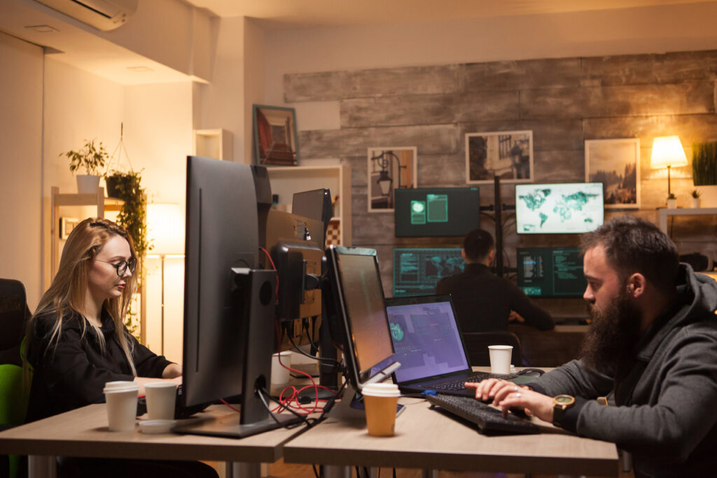 KLR IT support technicians assisting staff with system maintenance in a modern office environment