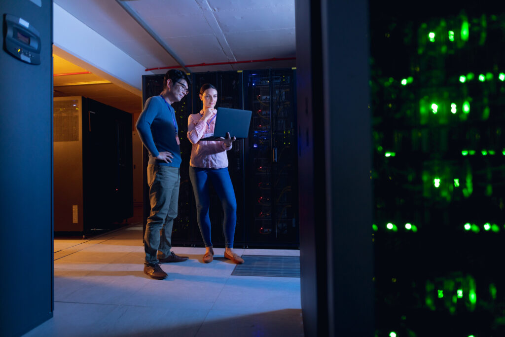 Employees reviewing KLR’s disaster recovery dashboard for data failover status